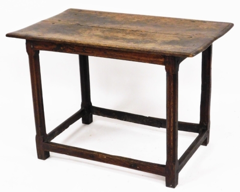 A 17thC oak table, on square chamfered legs and block base with two panelled top, 60cm high, 87cm wide, 53cm deep. (AF)