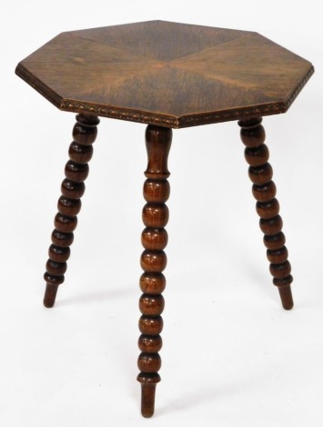 An oak gypsy table, with four diamond cut top on tripod hall legs with carved borders, 58cm high, 57cm wide.