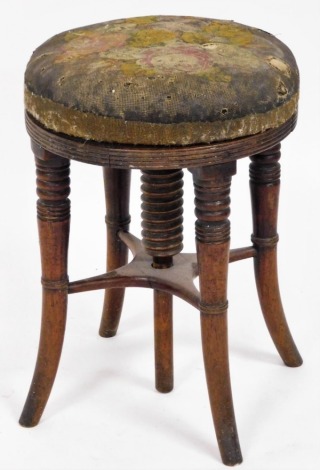 A Victorian mahogany piano stool, the floral upholstered top on four out splayed legs, 44cm high, 32cm diameter.