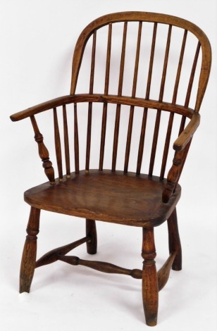 An early 19thC ash and elm Windsor chair, with spindle back and solid seat, 93cm high, 55cm wide, 40cm deep.