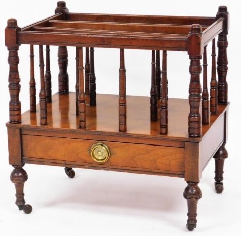 An early 20thC walnut canterbury, with magazine rack top above single drawer, on castors, 53cm high, 50cm wide, 35cm deep.