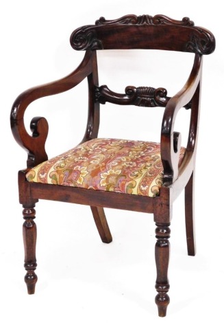 A William IV mahogany carver chair, with carved flecked back and scrolled arms on tapered supports with drop in seat, 86cm high, 54cm wide, 50cm deep.