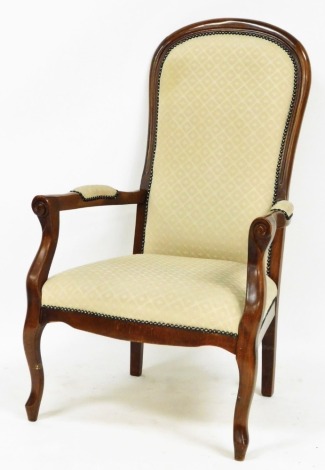 A beech framed armchair, with cream chequered upholstery with buttoned exterior, on shaped arms with splayed feet. The upholstery in this lot does not comply with the 1988 (Fire & Fire Furnishing) Regulations, unless sold to a known exporter or upholster