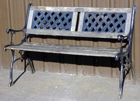 A cast iron and wooden slatted garden bench, with pierced slat with plaque Steven Joyce Mum and Dad, thinking of you, painted black ends, 80cm high, 120cm wide, 52cm deep.