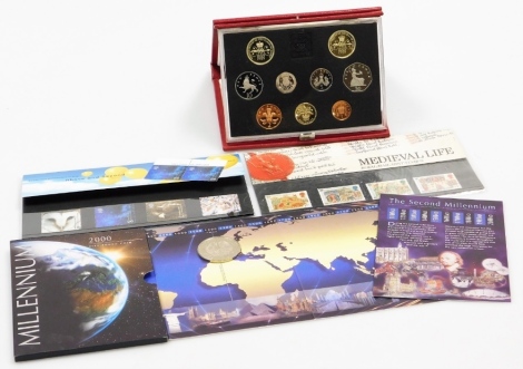 Various coins and first day covers, to include a 1989 cased coin set, a millennium 2000 five pound coin, medieval life mint stamps, and above and beyond mint stamps. (4 cases)