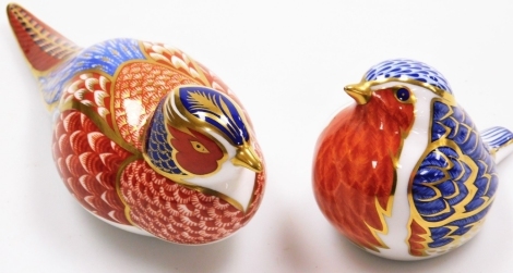 Two Royal Crown Derby paperweights, one of a robin with silvered stopper, 7cm high, and another of a seated pheasant with silvered stopper, 16cm wide.