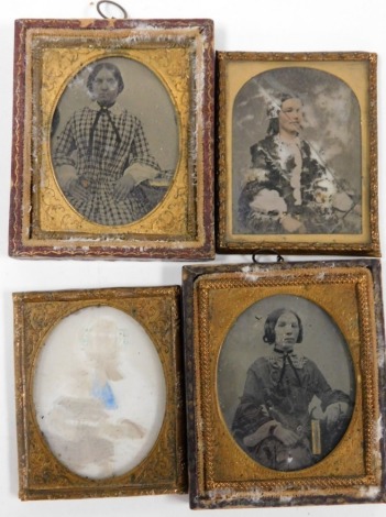 A group of daguerreotype photographs, each depicting figures of ladies in gilt frames. (AF)