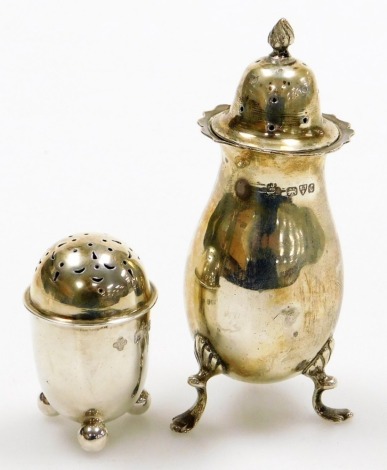 Two silver pepper pots, to include George V example London assay, and a large fluted design example marked Oxford, George V (2). 2¼oz.