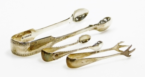 Three sets of silver sugar nips, to include a pair of claw handled silver nips, Sheffield 1939, a pair of feather patterned small sugar nips, Birmingham possibly George V, and a pair of larger Sugar nips with engine turned decoration, Sheffield 1930's 2½o