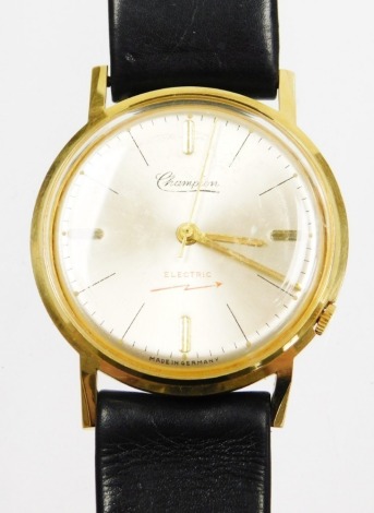 A Champion gentleman's German electric wristwatch, numbered 09685, with a silvered colour dial in a gold plated outer rim, on a black leather strap, the dial 3cm dial.