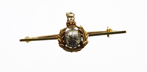 A Royal Marines sweetheart brooch, with central globe emblem surrounded by the Royal Marines figure, on a yellow metal pin stamped 14ct, 4.5cm wide, 3.3g all in.