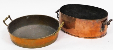 Two copper pans, to include a circular skillet with brass handles, 45cm diameter, and an oval copper pan, 40cm wide. (2)