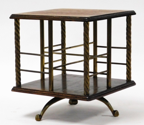 An Edwardian table top revolving bookcase, with oak top and brass sectional shelves, on three splayed feet, 30cm high, 27cm x 27cm.