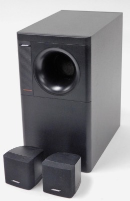 A Bose Acoustimass speaker system, with large speaker and two smaller speakers, the largest 35.5cm high.