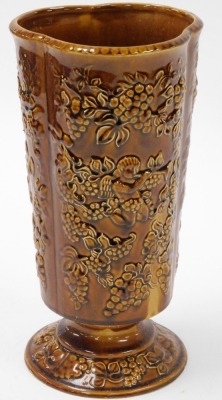 An Arthur Wood treacle glazed vase, with four panels of berries and cherubs, 36cm high.