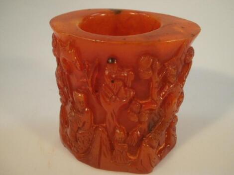 A Chinese reconstituted amber brush pot decorated with figures in a landscape