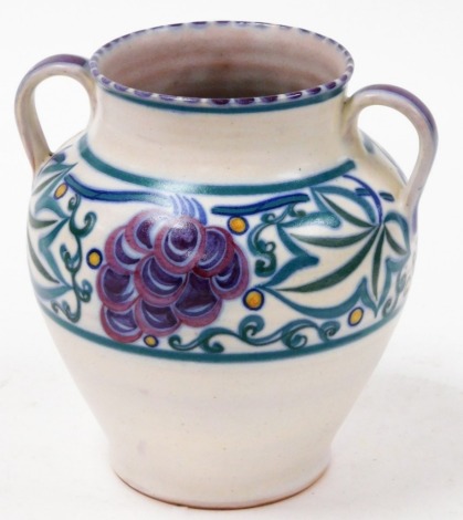 A Poole pottery vase, with green and purple design, with two ring handles, 20cm high.