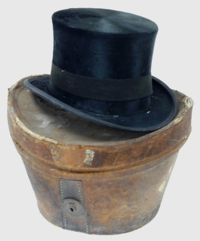 A gentlemans top hat, with black outer calf skin marked to rim, natural tanned calf in a leather carry case, the top hat interior measurements, 16cm x 19.5cm and the hat 13cm wide x 26.5cm deep.