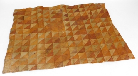 A vintage car blanket, with various tan and light brown suede triangle sections, with a faux fur lined interior, 114cm x 154cm.