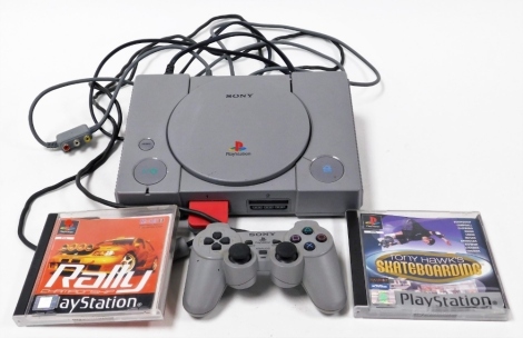 A Sony Playstation One console, and two games, Tony Hawks Skateboarding, and Rally Championship, together with one controller.