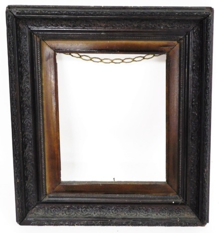 An ebonised picture frame, with brown floral detailed finish, 50cm high, 43cm wide.