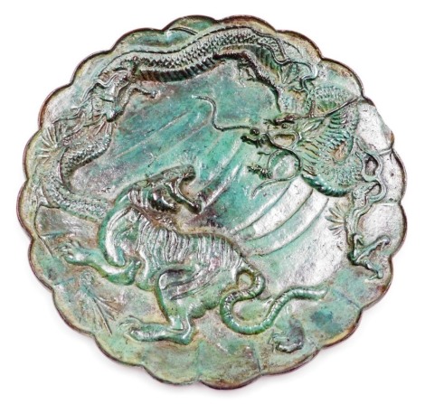 An early 20thC Chinese bronze plate, depicting tiger and dragons, heavily patinated green finish, 23cm wide.