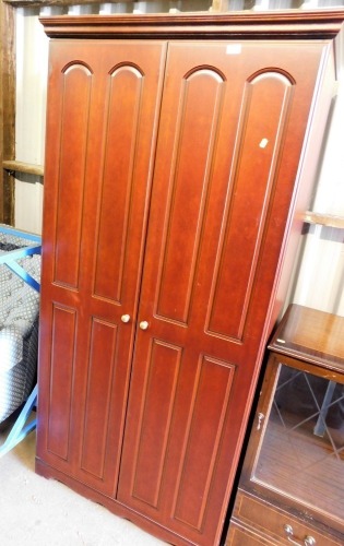 A modern finish double wardrobe, with panelled arch door, and a beech interior.