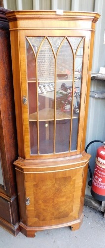 A yew wood corner cabinet.