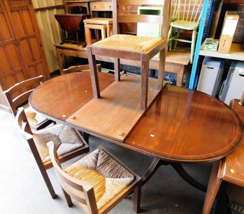 A set of five oak and rush seated dining chairs, and a reproduction twin pedestal dining table.