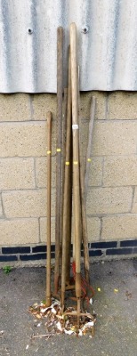 A group of various tools, garden hose, rakes, etc.