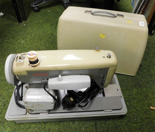 A cased electric sewing machine.