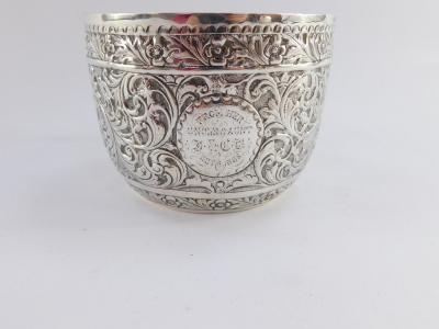 A Victorian silver drinking cup, with hammered floral detailing and central circular crest bearing the initials BMV, with front inscription From Her Uncle and Aunt J & CB, October 1885, Charles Stuart Harris, London 1884, 8cm high, 6¾oz. - 11