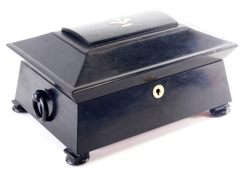 A Victorian ebony workbox, the domed lid inlaid with mother of pearl and brass, with a fleur de lys and a coronet, enclosing a fitted interior with embroidered covers, mother and pearl and bone spools, etc., on bun feet, 31cm wide.