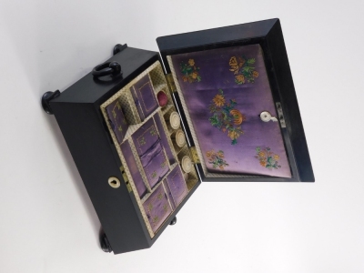 A Victorian ebony workbox, the domed lid inlaid with mother of pearl and brass, with a fleur de lys and a coronet, enclosing a fitted interior with embroidered covers, mother and pearl and bone spools, etc., on bun feet, 31cm wide. - 2