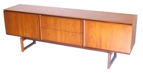 A 1960/70s White and Newton teak low sideboard in the Danish style, with an arrangement of two drawers flanked by two doors on end supports, 69cm high, 199cm wide.