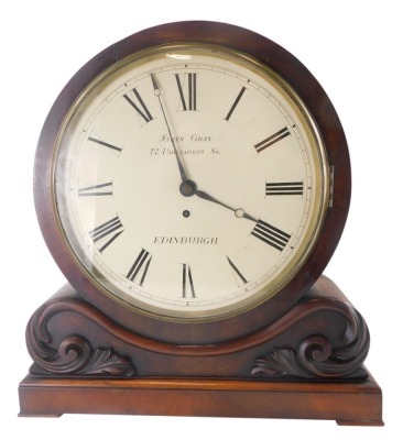An early Victorian figured mahogany mantel clock, the drum shaped case with painted dial for James Gray, 12 Parliament Square, Edinburgh, the rectangular base embellished with foliate scrolls, fusee movement, 45cm high.