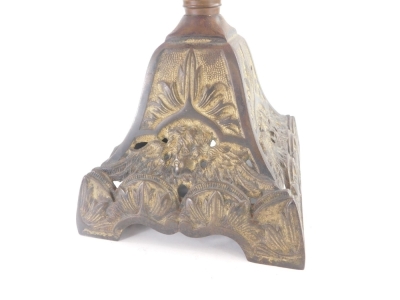 A Victorian cast iron oil lamp, with associated frosted shade, pink opaque moulded reservoir with white enamel decoration, the base decorated with masks, etc., 60cm high overall. - 2