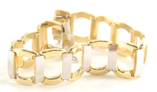 A modern bracelet, of bi colour design with outer yellow gold links, and white gold link bars, yellow metal, stamped 15c, 21cm long, 22.1g.