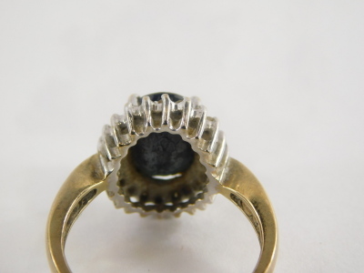 A 9ct gold sapphire and diamond dress ring, sapphire approx .25cts, the central oval cut sapphire surrounded by tiny diamonds, each in white gold setting on a yellow metal band, ring size P½, 4.6g all in. - 2