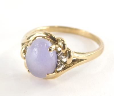 A 9ct gold dress ring, with central pale purple cabachon cut amethyst, and cz set shoulders and twist knot and pierced design splayed metal work, ring size R, 3.2g all in.