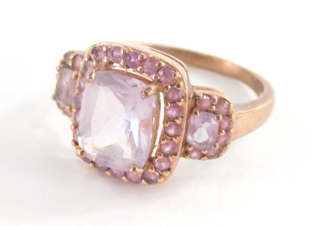 A 9ct rose gold dress ring, set with pink and purple topaz stones, with rectangular central purple stone and outer design round brilliant cut pink stones, in a rose gold coloured setting stamped QVC, ring size P½, 4.9g all in.
