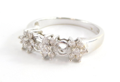 A 9ct white gold diamond dress ring, set with three diamond floral clusters and open work loop design, marked QVC, ring size O, 3.3g all in.