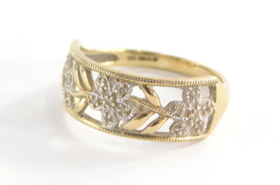 A 9ct gold dress ring, with rectangular panel set with three flowers and six leaf design, each set with cz stones, in oval pierced decoration, ring size R½, 2.7g all in.