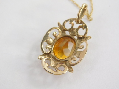 A 9ct gold pendant and chain, the floral pendant set with citrine, 3cm high, on a fine link chain, 46cm long, 2.3g all in. - 2