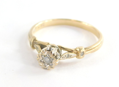 A 9ct gold diamond solitaire ring, on a raised setting with central stone approx. 0.10ct in an illusion oval setting with two tiny diamonds set shoulders, ring size U, 2.6g all in.