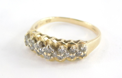 A 15ct gold dress ring, of half hoop design, set with tiny diamonds in claw setting with twist design backing, on a raised and pierced shank, 3.3g all in.