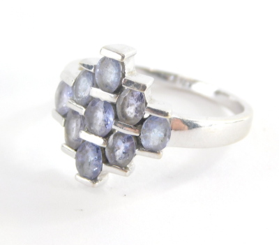 A dress ring, of layered design set with oval pale amethyst with three row central bar, and graduated outer layers, white metal, unmarked, ring size O, 3.6g all in.