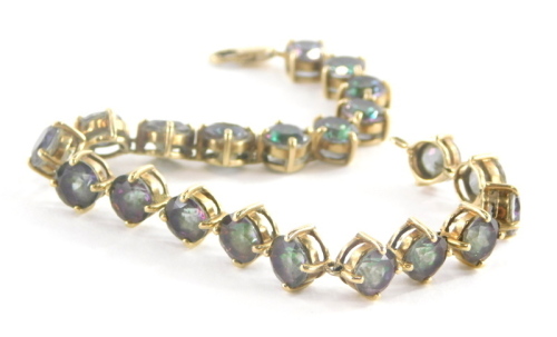 A 9ct gold sunset topaz bracelet, set with circular cut multi faceted topaz, 6.4 x 4.4, the yellow metal bracelet marked 375 to clasp 21cm long, 20g all in.