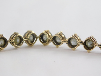 A 9ct gold sunset topaz bracelet, set with circular cut multi faceted topaz, 6.4 x 4.4, the yellow metal bracelet marked 375 to clasp 21cm long, 20g all in. - 2