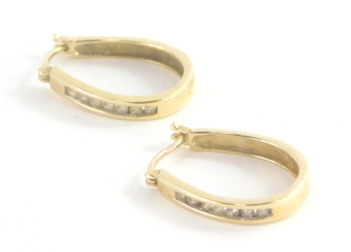 A pair of 9ct gold and diamond set hoop earrings, with seven tension set tiny diamonds to each hoop, 2cm high, 3.3g all in.